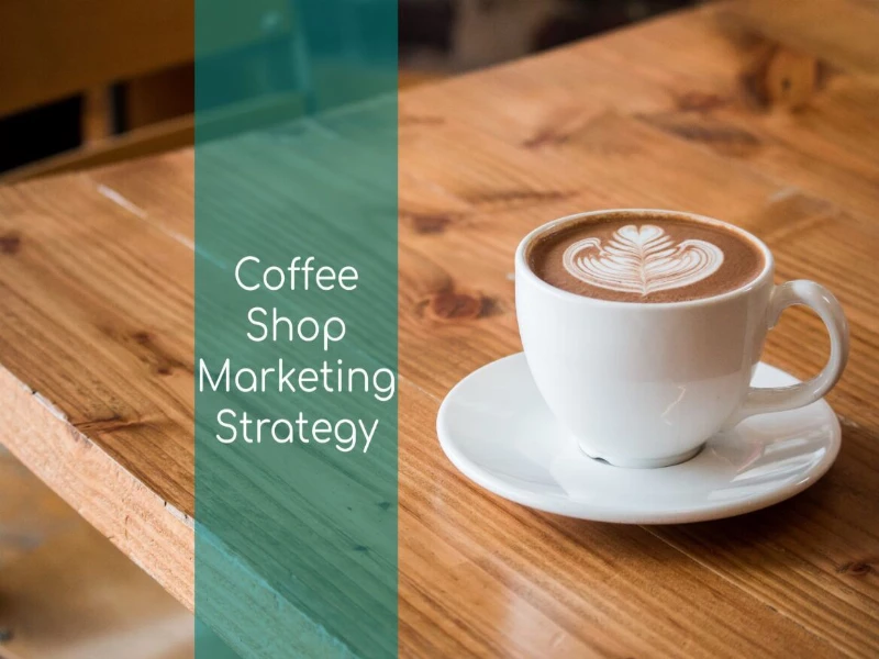 How To Create A Coffee Shop Marketing Strategy 16 Coffee cup on a coffee shop table with the words Coffee Shop Marketing Strategy